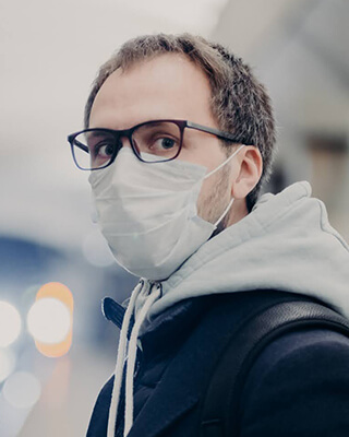 Wearing a face mask and glasses